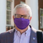 Welcome back. Welcome home. Portrait of President Phil Oldham wearing a face covering.