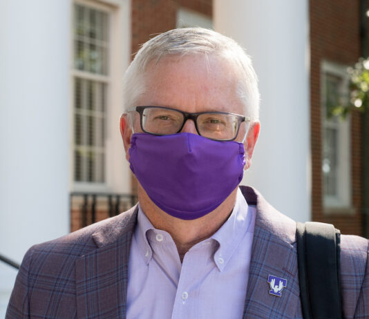 Welcome back. Welcome home. Portrait of President Phil Oldham wearing a face covering.