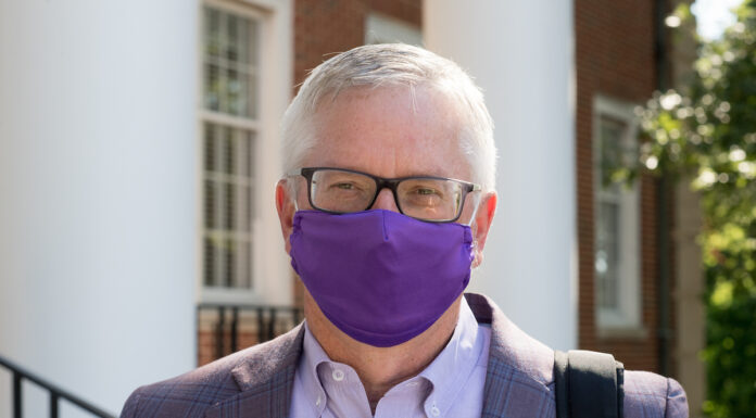Welcome back. Welcome home. Portrait of President Phil Oldham wearing a face covering.