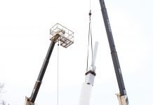 Ascension Ascension sculpture being lifted by two cranes for installation.